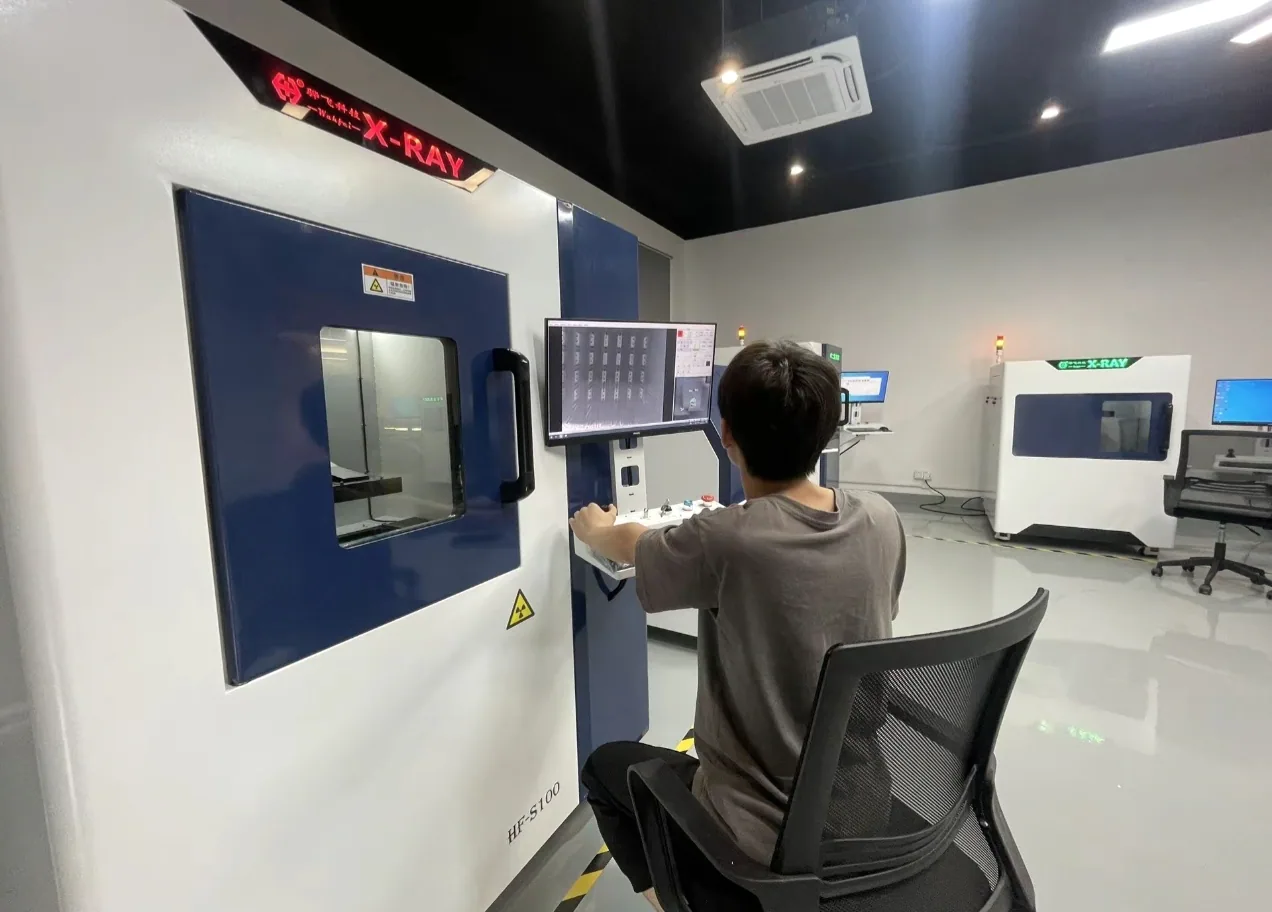 Technician operating X-ray inspection equipment for PCBA review
