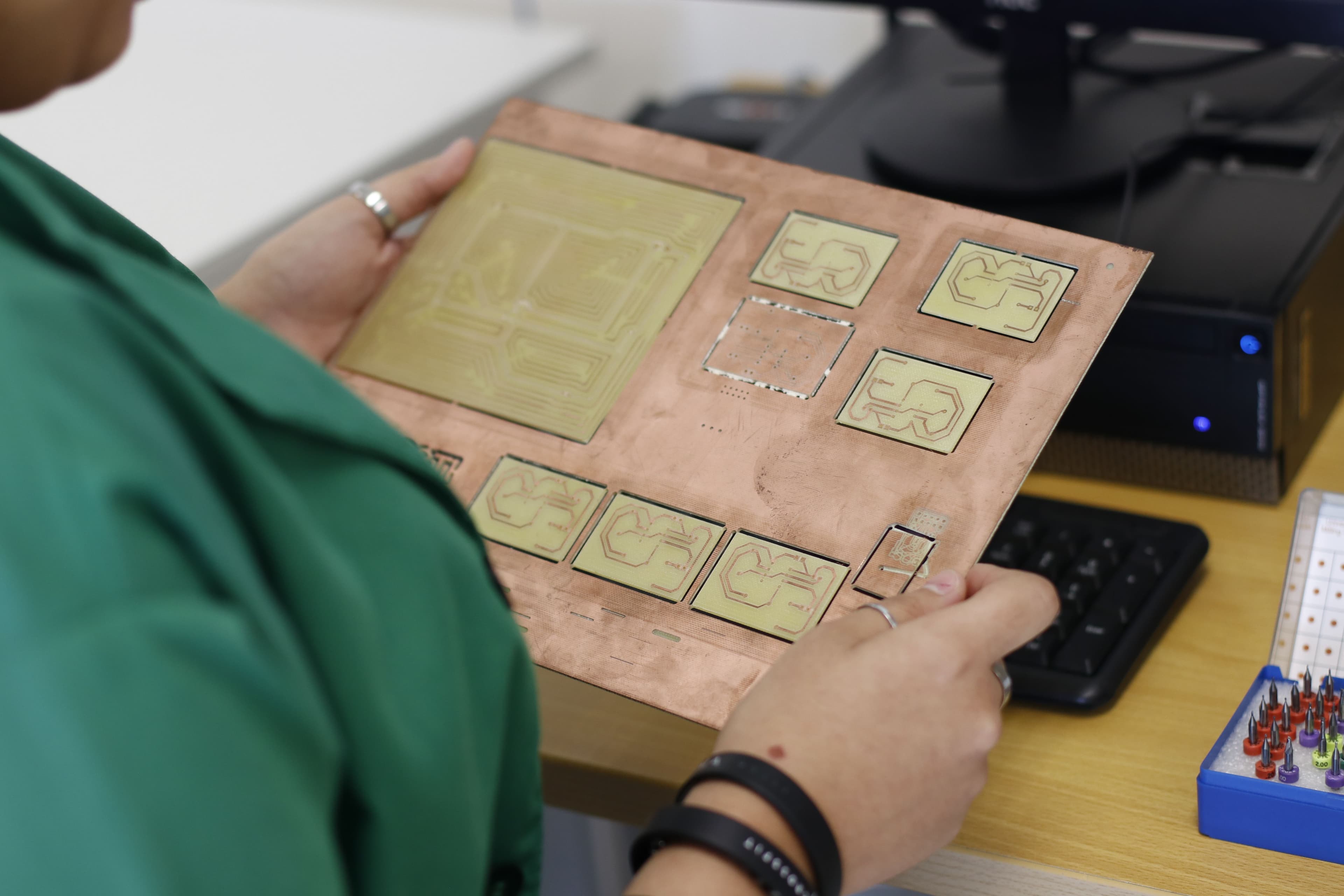 Technician comparing a printed circuit board panel with project information