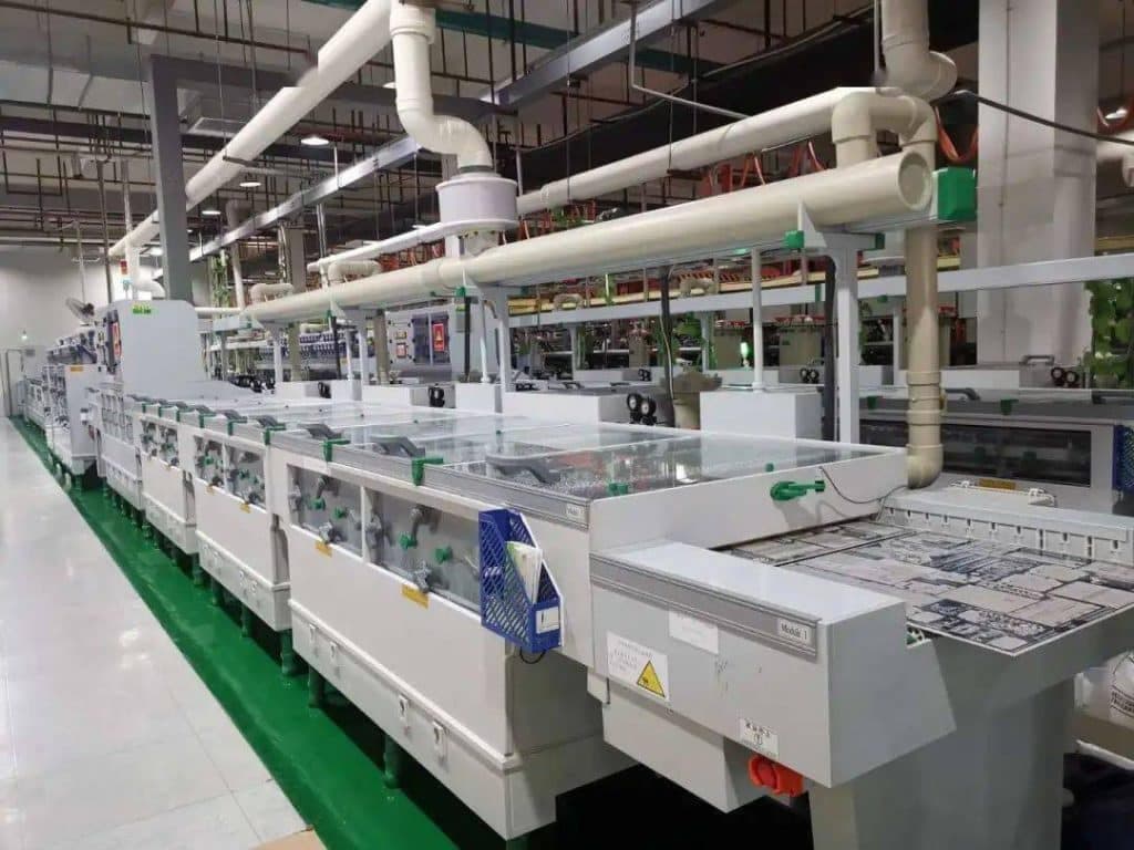 Printed circuit boards passing through a wet-processing line